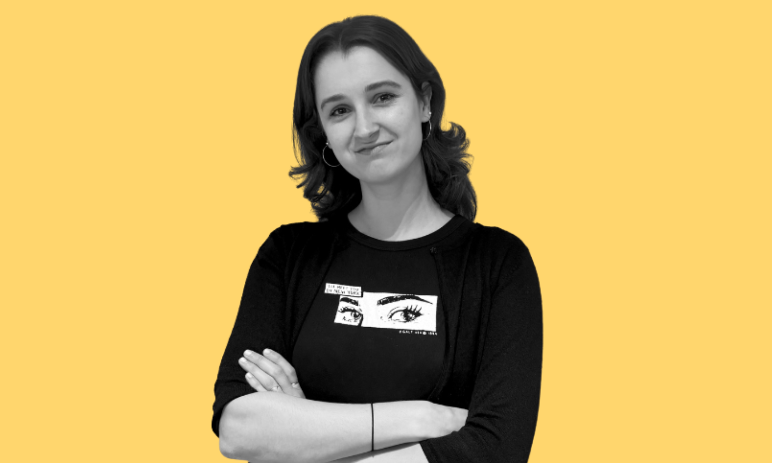 Black and white image of Olivia smiling on a yellow background