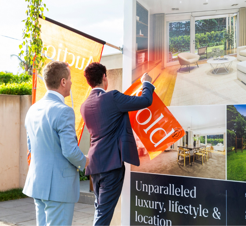 Gary Peer agents putting up a sold sign on a house