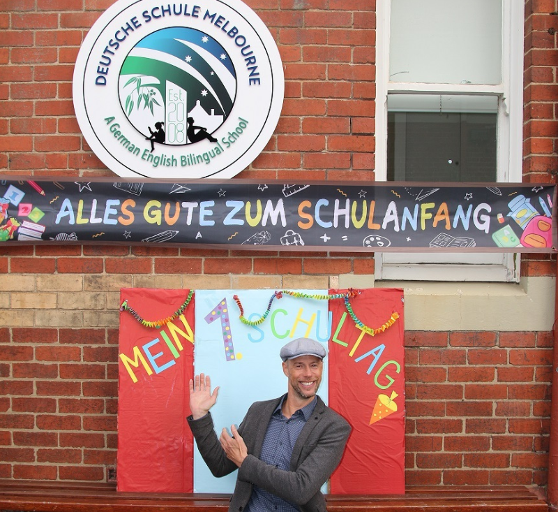 DSM principle posing happily in front of the school